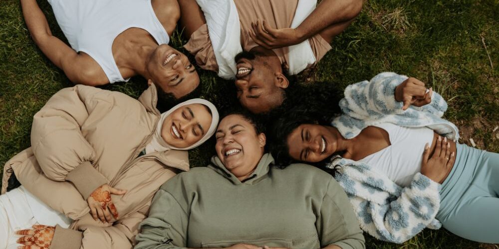 diverse group laying on grass